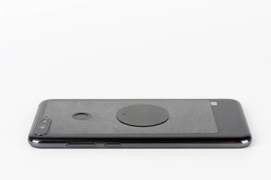 Touch screen smart phone in silicone cover. Metal plate on the back of the phone. Accessories for magnetic car phone holder. 