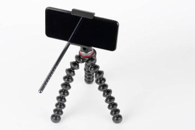 Touch screen smartphone on mount and flexible tripod. 