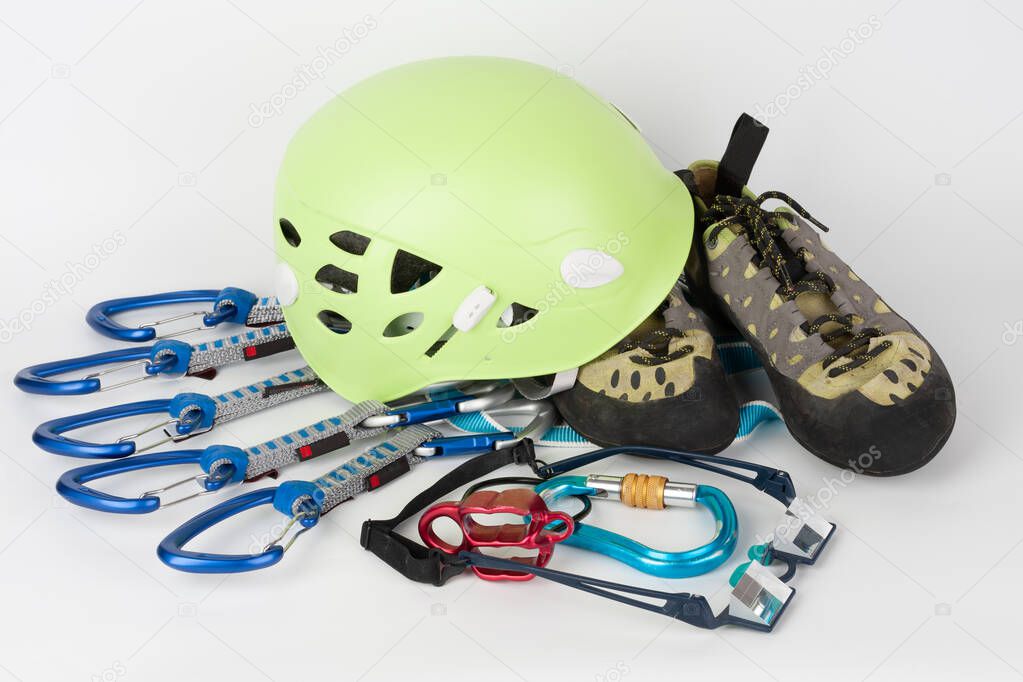 Five quick draws on  sewn loop sling, belay device, climbing footwear, climbing helmet and belay glasses.  