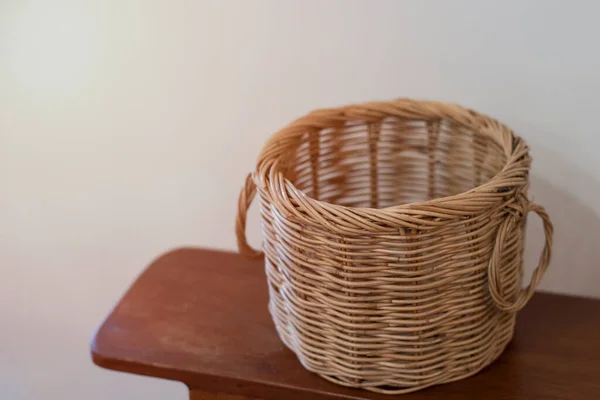 Brown Wicker Basket Wooden Table Cement Wall — Stock Photo, Image