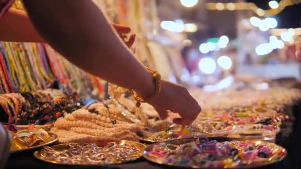 Femme touristique choisissant bijoux collier au marché de nuit rue. Ralenti 4K fermer les images. Phuket Town, Thaïlande. — Video