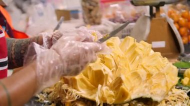 Gece Pazarı 'nda meyve soyan meyve satıcısı. Egzotik Asya Tropikal Meyve Sokağı Gıda Konsepti. Phuket Town, Tayland. Yüksek kaliteli 4K video görüntüleri.