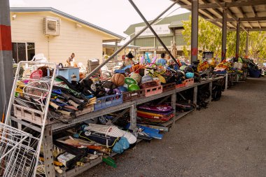 Old sporting goods being recycled at a dump shop run by a not for profit charity with balls and hoops, cricket pads, and boogie boards.