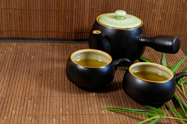 Japanese Teapot Cups Green Tea Bamboo Mat Bamboo Leaves — Stock Photo, Image