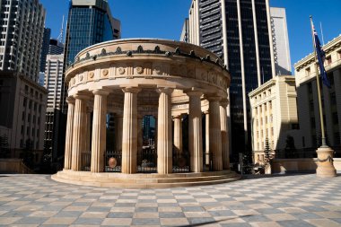 Brisbane, Queensland 'in kalbinde sonsuz alevi barındıran Anzak kare tapınağı. Arka planda şehir manzarası yükseliyor..