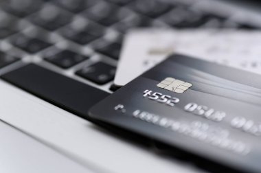 Bilgisayardaki kredi kartının çevrimiçi mağazalardan ve çevrimiçi alışveriş için yapılan ödemeleri yakından çek. İnternet alımı kavramı. Arkaplan için seçici odak