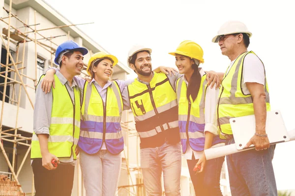 Group Happy Contractors Engineers Formats Safety Vests Helmets Stand Construction — Zdjęcie stockowe