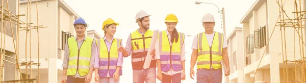 Group Happy Contractors Engineers Formats Safety Vests Helmets Stand Construction — Zdjęcie stockowe