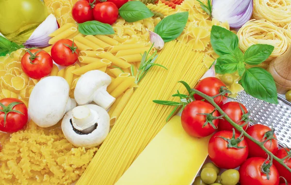 Ingredients for making pasta. Different types of pasta, vegetables, cheese and other products.