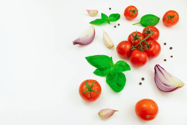 Tomatoes, mushrooms, spices and fresh herbs on a white background. Ingredients for cooking. Copy space.