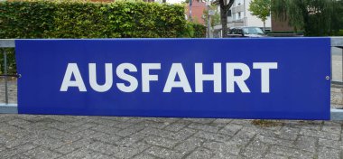 A large blue shield with 'Ausfahrt' written on it. This is German for Exit for vehicles.