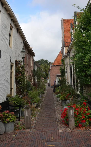 Steegje Bij Versterkte Muur Met Kleine Oude Huizen Met Bloempotten — Stockfoto