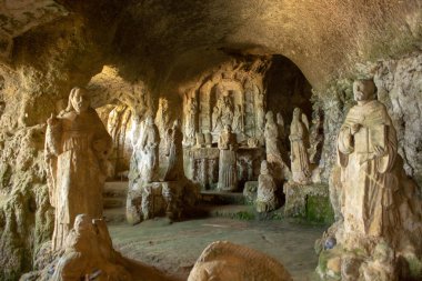 Church of Piedigrotta carved into the rocks full of enchanting stone statues