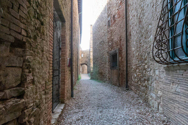 A quiet street of residential buildings in the historic medieval village of Panzano in Tuscany, Italy .