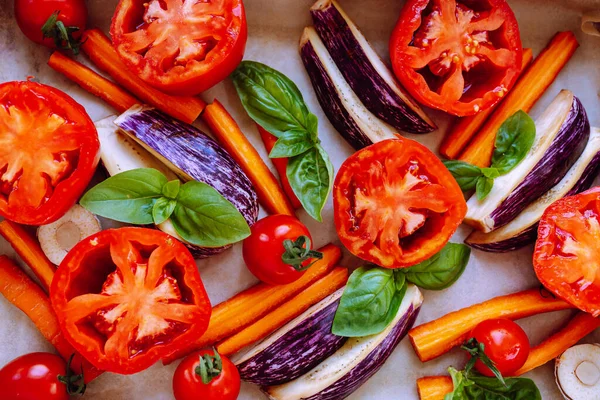 vegetable layout in red colors, fresh vegetables for roasting. Slice of tomato close-up, vegetarian pizza, healthy food