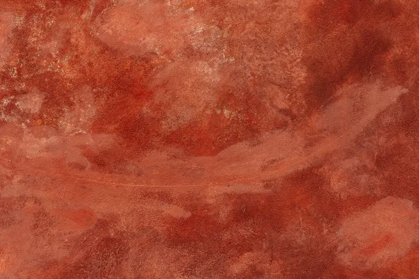 wall is made of decorative plaster, painted with bright orange paint, with streaks and scuffs. Grunge style, vintage background. Venetian plaster, a variety of decorative wall covering, red warm color, primer, plaster texture