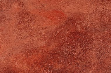 Venedik alçısı, çeşitli dekoratif duvar örtüsü, kırmızı sıcak renk, astar, alçı doku. Duvar dekoratif alçıdan yapılmış, parlak turuncu boyayla boyanmış, çizikler ve çizikler var..