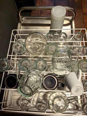Portoroz, Slovenia. 04.12.2022. Dirty and unwashed dishes standing on the table in a cafe. Cups of coffee, plates, spoons, forks are in the sink. After holidays. 