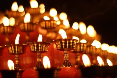 Tapınak Manastırı 'ndaki 108 Yağ Lambası Festivali' nde Budist Eski Sunak Mumları. Yağlı Lambaların Güzel Huzurlu Manzarası ve Dua İçin Sallanan Alev
