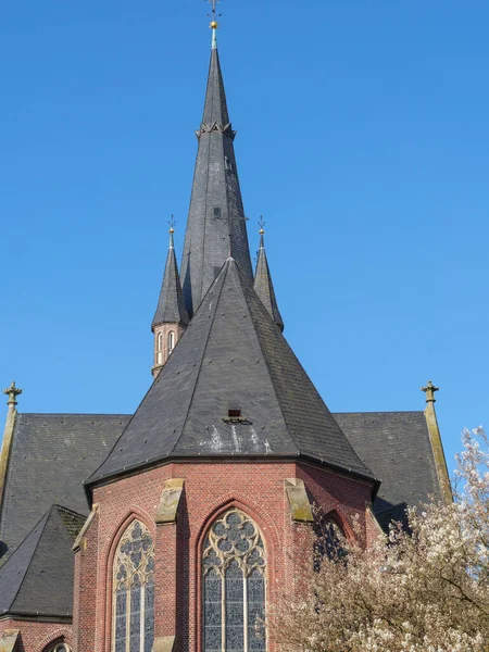 stock image windmill and church in westphalia