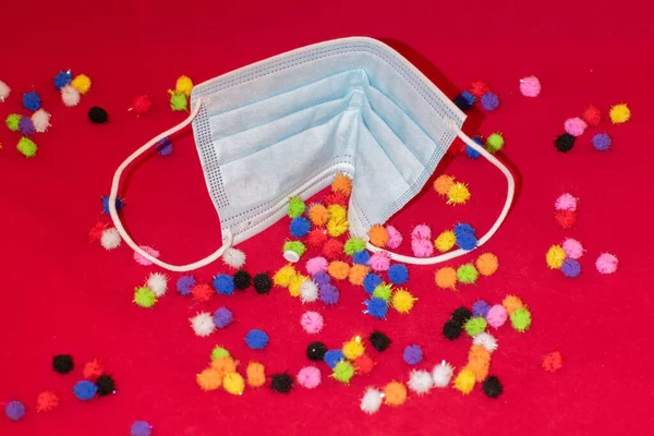 Vaduz, Lihtenştayn, 17 Aralık 2021 Farklı virüs parçacıkları ve kırmızı zemin üzerinde tıbbi maske