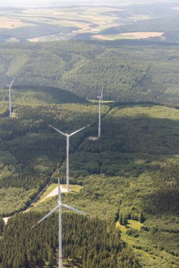Baden Wurttemberg, Germany, July 8, 2022 Wind turbines on a green hill seen from a small plane