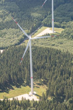 Baden Wurttemberg, Germany, July 8, 2022 Wind turbines on a green hill seen from a small plane