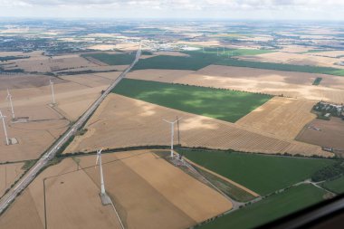Naumburg, Saxony Anhalt, Germany, July 11, 2022 Wind power stations on a meadow seen from a small plane