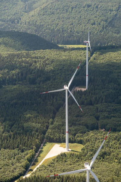 Baden Wurttemberg, Germany, July 8, 2022 Wind turbines on a green hill seen from a small plane