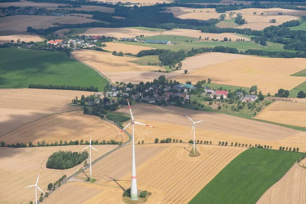 Doebeln, Saxony, Germany, July 11, 2022 Wind energy stations are rotating on a meadow seen from a small plane