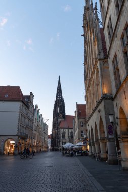 Muenster, Germany, July 8, 2022 Illuminated buildings in the historic old town in the late evening
