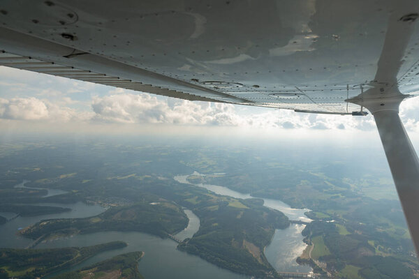 Olpe, North rhine Westphalia, Germany, July 8, 2022 Flight overhead the lake Biggesee with a small plane