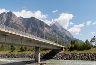 Truebbach, Switzerland, April 28, 2022 View along the rhine river and the majestic alps at the border to Liechtenstein on a sunny day