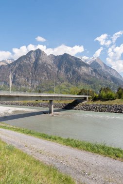 Truebbach, Switzerland, April 28, 2022 View along the rhine river and the majestic alps at the border to Liechtenstein on a sunny day