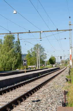 Nendeln, Liechtenstein, April 28, 2022 Railway track system through the town on a sunny day
