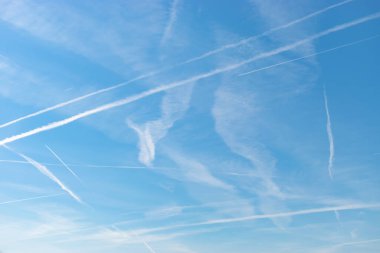 Switzerland, May 11, 2022 Contrails formation on a sunny day in spring time