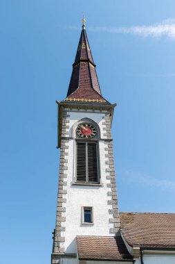 Stettfurt, Switzerland, May 11, 2022 Tower of the local church on a sunny day