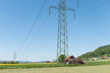 Lommis, Switzerland, May 11, 2022 High voltage power pole station in a rural landscape area