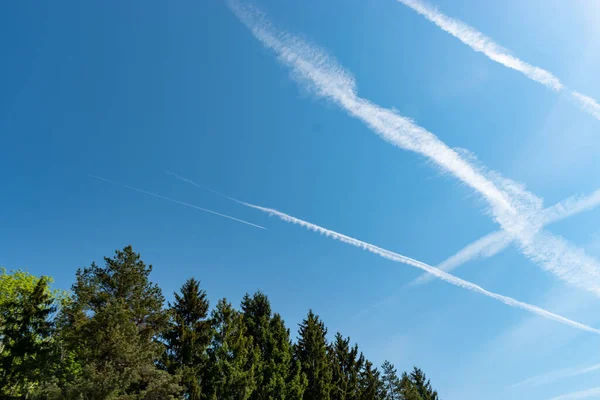 Switzerland, May 11, 2022 Contrails formation on a sunny day in spring time