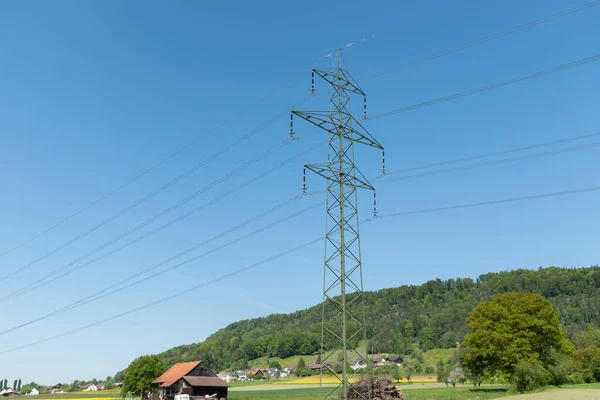 Lommis, Switzerland, May 11, 2022 High voltage power pole station in a rural landscape area