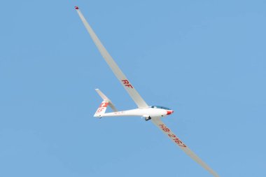 Saint Gallen, Altenrhein, Switzerland, April 18, 2022 Glider is circling in the clear blue sky