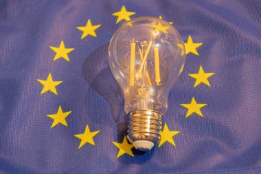 Vaduz, Liechtenstein, September 6, 2022 Light bulb is lying on an european flag to demonstrate the energy crisis