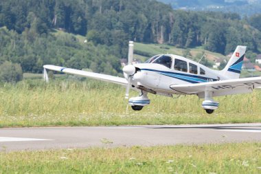 Wangen-Lachen, Switzerland, July 31, 2022 Piper PA28-181 Archer II propeller plane is landing on a small airfield