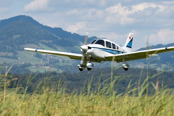 Wangen-Lachen, Switzerland, July 31, 2022 Piper PA28-181 Archer II is landing on a small airfield
