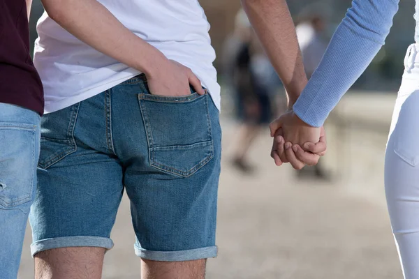 Closeup Man Touching Butt His Friend While Holding Girlfriend Hand — Stockfoto