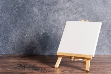 Kırsal arkaplanda beyaz tuval ve fotokopi alanı ile resim sehpası