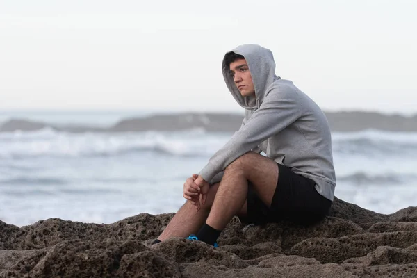 Worried Hispanic Teenager Sitting Rocks Sea Anxiety Depression Adolescence Concept — Fotografia de Stock