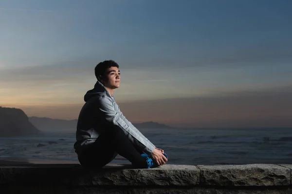 Positive Hispanic Adolescent Stretching Sunset Coast — Stock Fotó