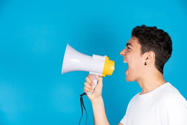 Hispanic Teenager Boy Shouting Megaphone Speaker Copy Space Isolated Blue — 스톡 사진