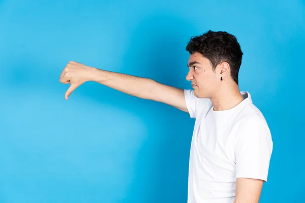 Side View Negative Hispanic Teenager Boy Thumbs Isolated Blue Background — 스톡 사진
